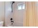 Bathroom features white tile, updated fixtures and a shower with sleek, black hardware at 925 Wolff St, Denver, CO 80204