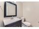 Updated bathroom with modern vanity, mirror, and fixtures, and a tiled floor at 925 Wolff St, Denver, CO 80204