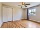 Bedroom featuring a large window, spacious closet, and beautiful, light-colored hardwood flooring at 925 Wolff St, Denver, CO 80204
