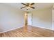 Open bedroom boasts hardwood floors, ceiling fan, and an adjoining room and closet at 925 Wolff St, Denver, CO 80204