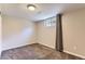 Cozy bedroom with neutral carpet, a window with curtains, and ample electrical outlets at 925 Wolff St, Denver, CO 80204