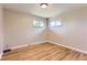 Bright bedroom featuring natural light from two windows and gleaming hardwood floors at 925 Wolff St, Denver, CO 80204