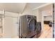 Laundry area featuring modern washer and dryer set, with an open doorway leading to another room at 925 Wolff St, Denver, CO 80204