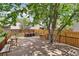 Outdoor deck with tables, seating, and mature trees at 19053 E 22Nd Dr, Aurora, CO 80011