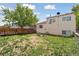 The property boasts a spacious backyard with a wooden deck, perfect for outdoor entertaining and relaxation at 19053 E 22Nd Dr, Aurora, CO 80011