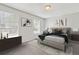 Bright bedroom with neutral colors, two windows, stylish decor, and a comfortable bed at 19053 E 22Nd Dr, Aurora, CO 80011