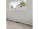 Bedroom features carpeted floors and a large window offering views of the neighborhood at 19053 E 22Nd Dr, Aurora, CO 80011