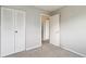 Bedroom features carpeted floors, closet, and entry to bathroom at 19053 E 22Nd Dr, Aurora, CO 80011