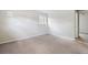 A bright bedroom with neutral carpet, and a window offering natural light at 19053 E 22Nd Dr, Aurora, CO 80011