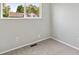 Bright bedroom with carpeted floor and a view of the neighborhood from the window at 19053 E 22Nd Dr, Aurora, CO 80011
