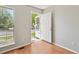 Light-filled entryway featuring modern wood floors and a view of the front yard at 19053 E 22Nd Dr, Aurora, CO 80011