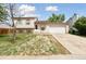 Charming home featuring an attached garage and driveway, with a front lawn at 19053 E 22Nd Dr, Aurora, CO 80011