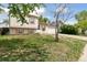 Charming home with manicured lawn and neutral siding, shaded by a mature tree at 19053 E 22Nd Dr, Aurora, CO 80011