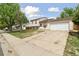 Well-maintained property featuring an attached garage and a long driveway, set in a quiet neighborhood at 19053 E 22Nd Dr, Aurora, CO 80011