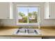 Close-up of stainless steel sink under a bright window in kitchen at 19053 E 22Nd Dr, Aurora, CO 80011
