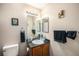 Bathroom featuring a mirrored vanity, updated sink, and artwork at 814 Pintail Ave, Brighton, CO 80601