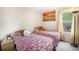 Cozy bedroom featuring twin beds and a large window at 814 Pintail Ave, Brighton, CO 80601