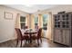Bright dining room featuring hardwood floors, neutral walls, and many windows at 814 Pintail Ave, Brighton, CO 80601