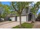Inviting two-story townhouse with a two car garage, driveway, and a tree at 814 Pintail Ave, Brighton, CO 80601