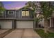 Charming two-story home with a large two car garage and driveway at dusk at 814 Pintail Ave, Brighton, CO 80601