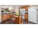 Well-equipped kitchen with wood cabinets, modern appliances, and an island at 814 Pintail Ave, Brighton, CO 80601