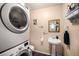 A tidy laundry area is conveniently located with a sink and storage at 814 Pintail Ave, Brighton, CO 80601