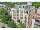 Aerial view of a multi-story building featuring patios and balconies, surrounded by mature trees at 340 S Lafayette St # 204, Denver, CO 80209