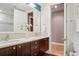 Modern bathroom featuring double sinks, dark wood cabinetry, and mosaic tile accents at 340 S Lafayette St # 204, Denver, CO 80209