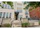 Charming building entrance with black awning, stone facade and lovely front patio at 340 S Lafayette St # 204, Denver, CO 80209