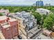 An aerial shot showcases a multi-story residential building with balconies, a rooftop terrace, and views of the city skyline at 340 S Lafayette St # 204, Denver, CO 80209