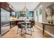 Eat-in kitchen featuring modern stainless steel appliances, dark cabinets, and a chandelier at 340 S Lafayette St # 204, Denver, CO 80209