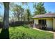 Backyard featuring a well-maintained lawn, a patio area, and mature shade trees at 2330 Yarrow St, Lakewood, CO 80214