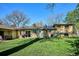 Lush green backyard with mature trees, outdoor grill area and a well-manicured lawn at 2330 Yarrow St, Lakewood, CO 80214