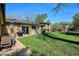 Well-maintained backyard featuring a patio, lush lawn, mature trees, and convenient barbecue grill at 2330 Yarrow St, Lakewood, CO 80214