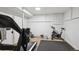 Basement home gym featuring exercise equipment including treadmill, bike and rowing machine at 2330 Yarrow St, Lakewood, CO 80214