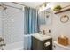 Updated bathroom featuring tile, a new vanity, gold fixtures and a shower with curtain at 2330 Yarrow St, Lakewood, CO 80214