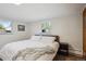 Cozy bedroom with neutral decor, large windows, and a comfortable bed setting at 2330 Yarrow St, Lakewood, CO 80214
