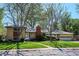 Charming brick home with a well-maintained lawn and mature trees creating an inviting curb appeal at 2330 Yarrow St, Lakewood, CO 80214