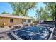Expansive backyard garden area including mature trees and wooden raised garden beds at 2330 Yarrow St, Lakewood, CO 80214