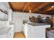 Cozy kitchen featuring a breakfast bar, ample white cabinetry, and an efficient layout at 2330 Yarrow St, Lakewood, CO 80214