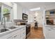 Well-lit kitchen with stainless steel appliances, white cabinets, and eat-in dining space at 2330 Yarrow St, Lakewood, CO 80214