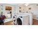 Convenient laundry area with modern washer and dryer units, adjacent to the updated kitchen and dining space at 2330 Yarrow St, Lakewood, CO 80214