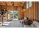 Comfortable living space with wood-paneled walls and sliding glass doors to an outdoor patio at 2330 Yarrow St, Lakewood, CO 80214