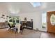 Inviting living room with a stone fireplace, skylight, and large windows offering ample natural light at 2330 Yarrow St, Lakewood, CO 80214