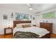 Serene main bedroom with hardwood floors, a large window with scenic views, and a ceiling fan at 2330 Yarrow St, Lakewood, CO 80214