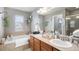 Spacious bathroom featuring a soaking tub, double sinks, and stylish accents for a luxurious experience at 1432 Red Mica Way, Monument, CO 80132