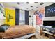 A bedroom with a large window, flags, and a study area, offering natural light and personality at 1432 Red Mica Way, Monument, CO 80132