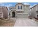 Inviting two-story home featuring a two car garage, an arched entryway, and tasteful landscaping at 1432 Red Mica Way, Monument, CO 80132