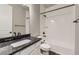 Bathroom featuring granite vanity, modern fixtures, and a shower-tub combo at 6712 Sea Oats Dr, Parker, CO 80138