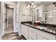 Bathroom featuring double sinks, granite counters, and a glass-enclosed shower at 6712 Sea Oats Dr, Parker, CO 80138